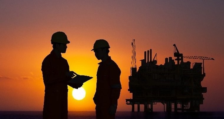 Field engineers reviewing operations at an offshore platform